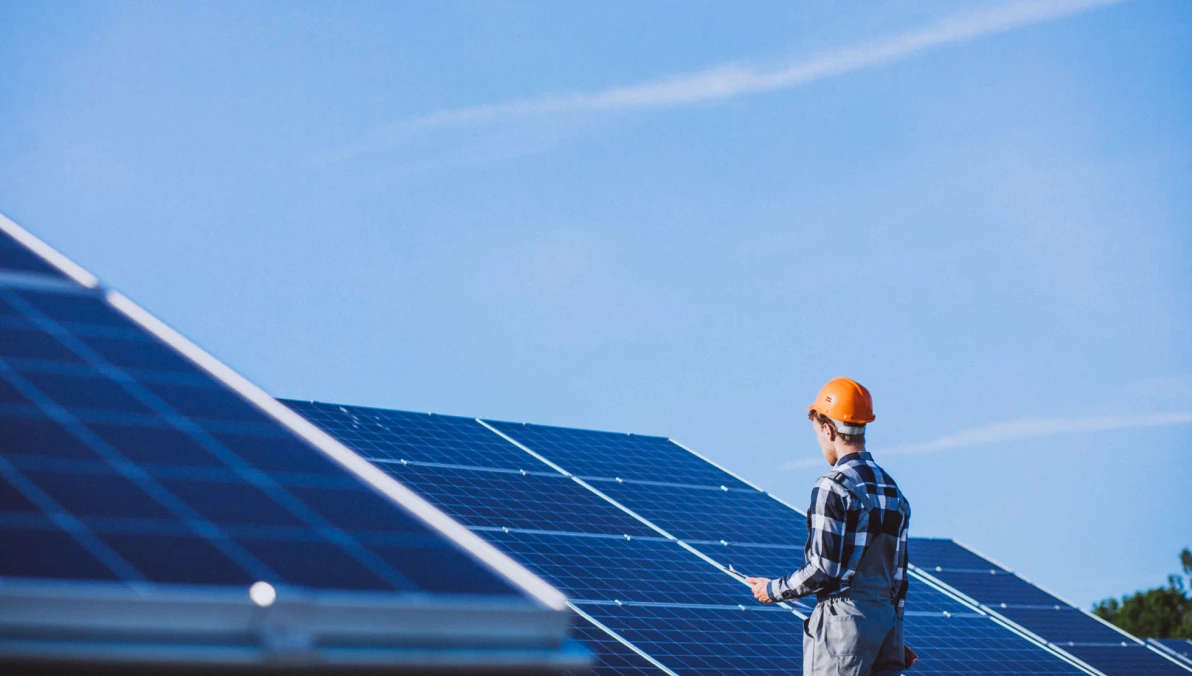 man-worker-field-by-solar-panels